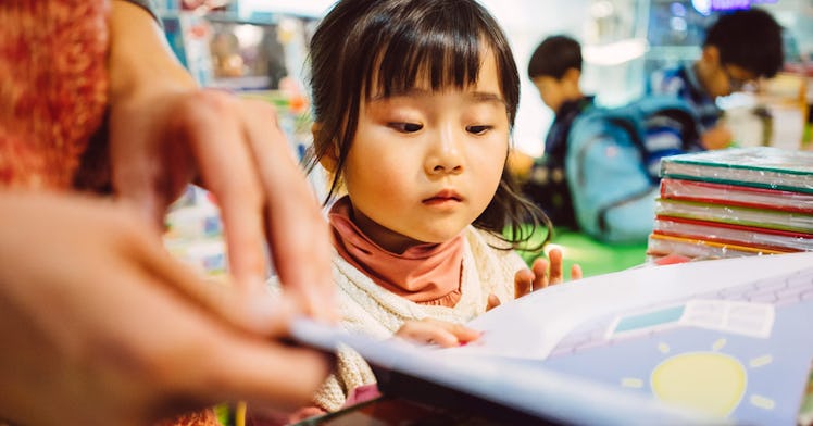 A kid reading a book about people of color
