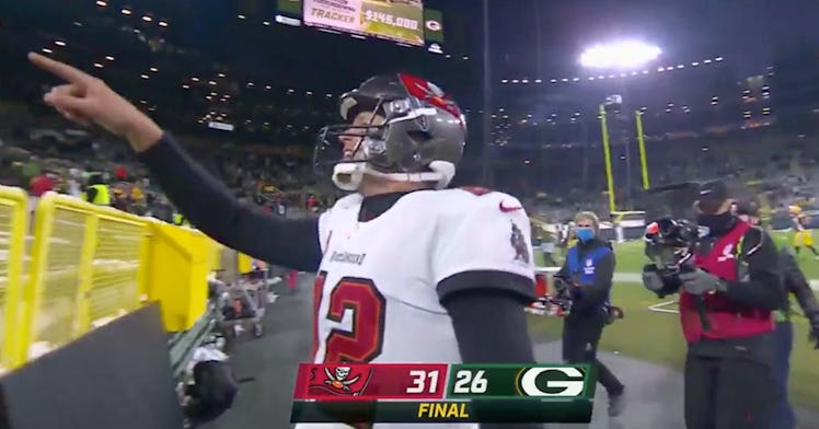 Tom Brady stands in a football field