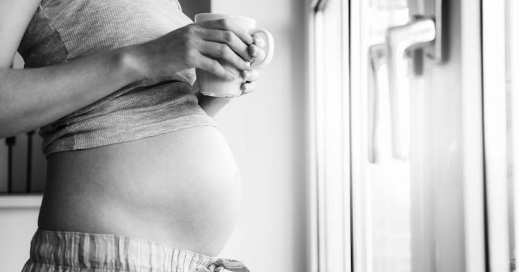 pregnant woman drinks a caffeinated drink