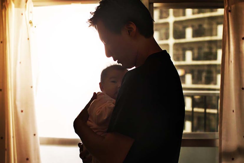 A dad on paternity leave holding his baby
