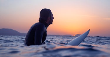 a newly divorced man surfs in the ocean in a bid to get over a divorce