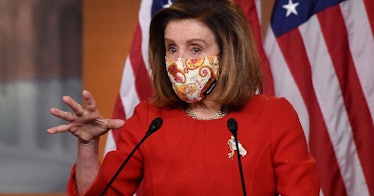 Nancy Pelosi wears a mask and a red dress