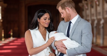 Meghan Markle and Prince Harry hold Archie after his birth