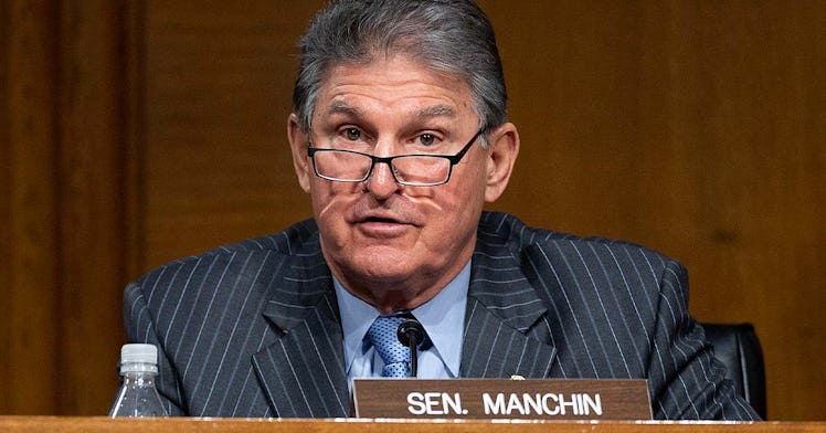 Senator Joe Manchin sits at a desk