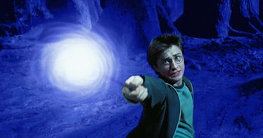 Harry Potter holding his magic wand and performing a spell