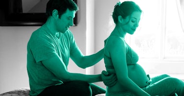 A man giving his pregnant partner prenatal massage