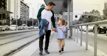 A dad and a son walking down the tram station