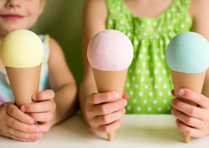 kids holding up construction paper ice cream cones of different colors