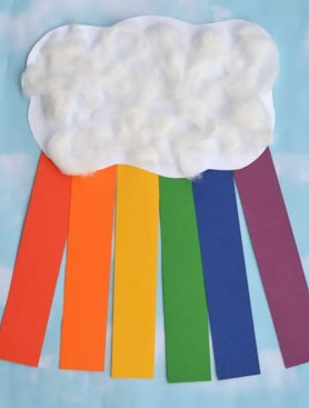 construction paper cloud with strips of colored construction paper coming out from behind, all on to...