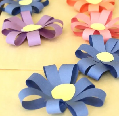 construction paper flowers sitting on a wooden table