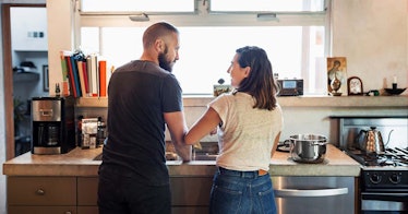 man and woman standing near sink having conversation