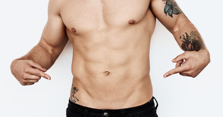 A man posing and showing his six-pack abs