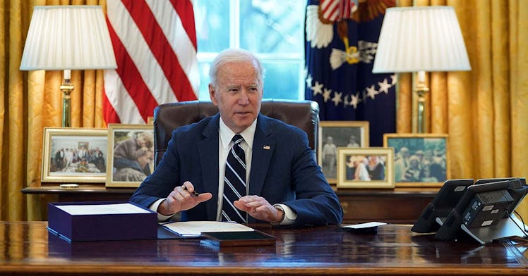 Biden sits at his desk in the Oval office
