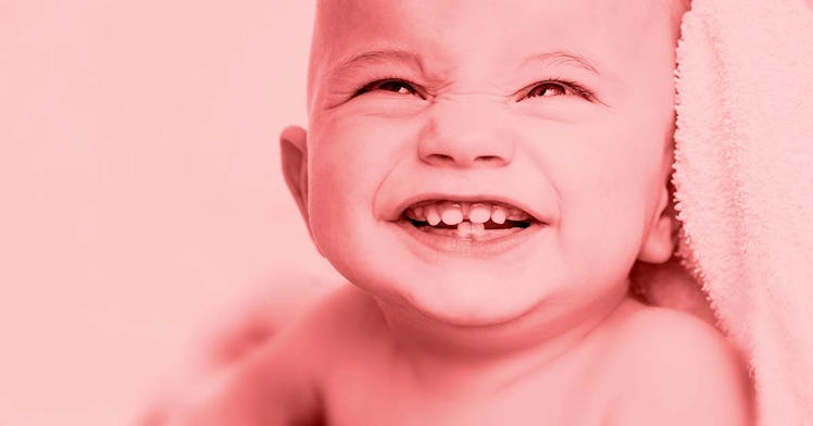 Smiling babby with baby teeth showing