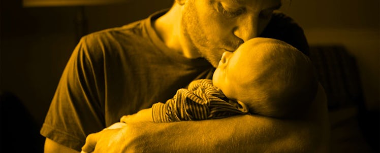 A father kissing his son that has a rare, life threatening genetic condition