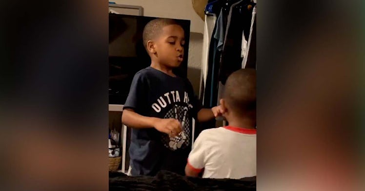 A big brother helps his younger sibling do breathing exercises