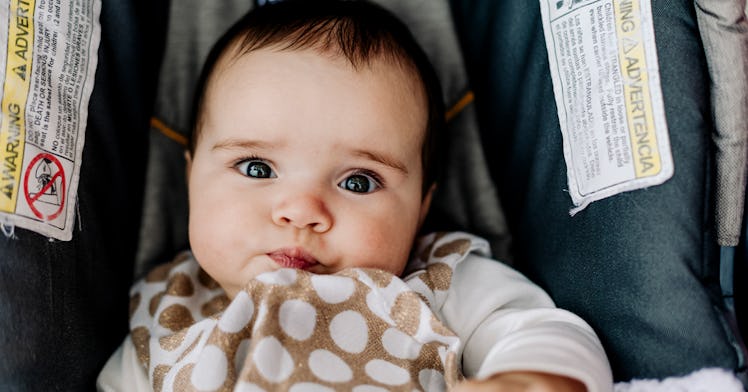 a baby cradled in a car seat, depicting safety with regards to car seat expiration dates