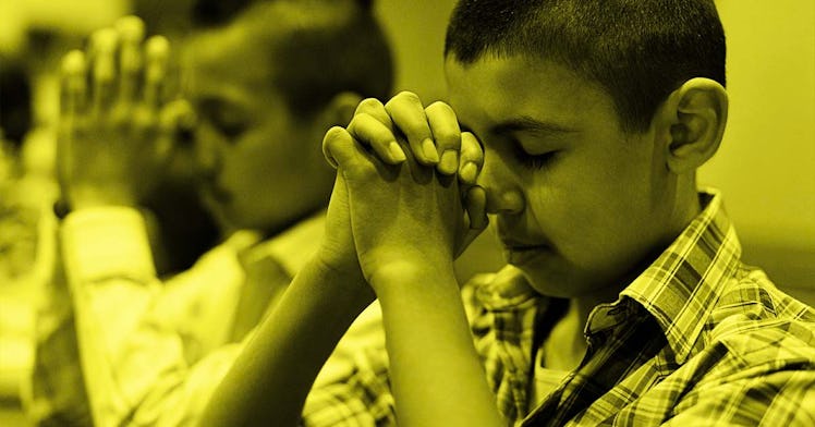 Two boys praying at a church
