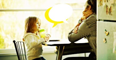 a father sitting at the dining with his daughter uses conversation starters for kids to drive a disc...