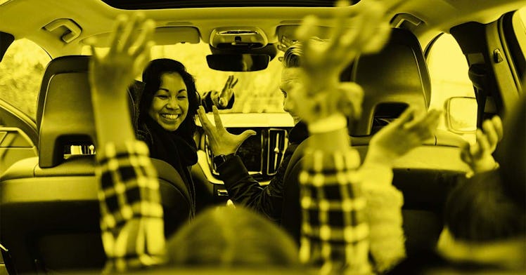 Happy family in a car taking the cross country road trip in America