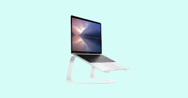 laptop on portable vertical silver laptop stand, isolated on aqua background