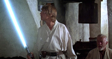Luke Skywalker with his father's lightsaber