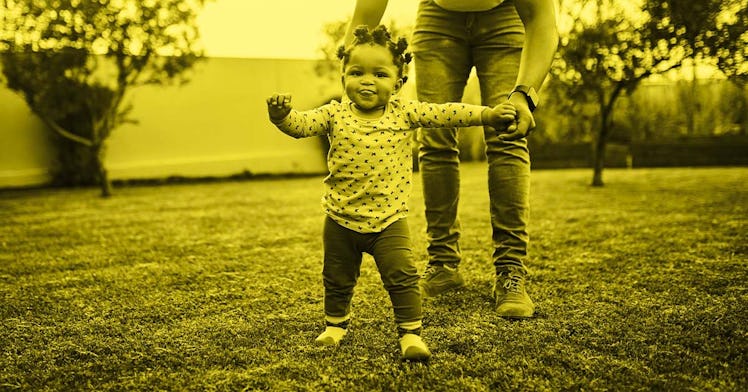 A mother standing next to her toddler who has learned she could run