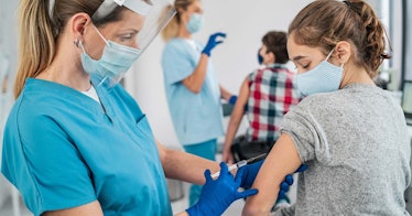 A kid receives a vaccine