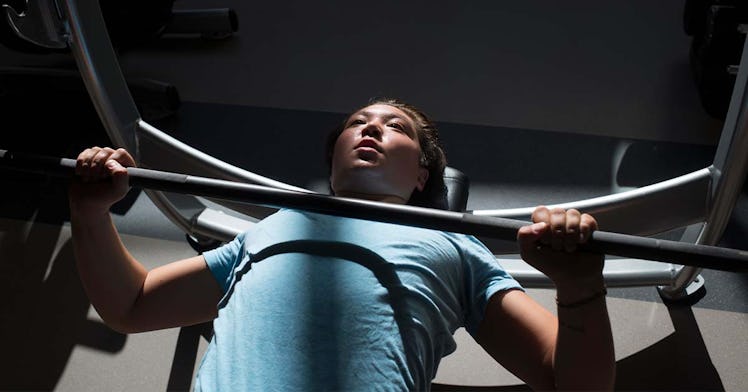 A Trans Athlete working out on bench