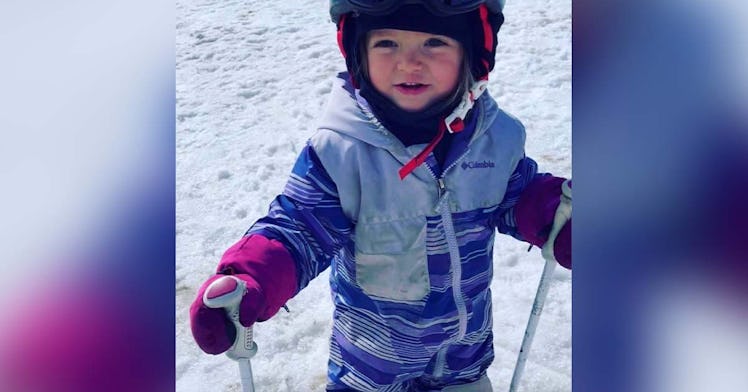 A 2-year-old skis down a mountain