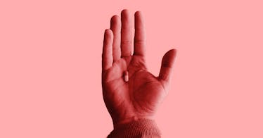 pink photo edit of someone's right hand with a single pill suspended in the center of the palm