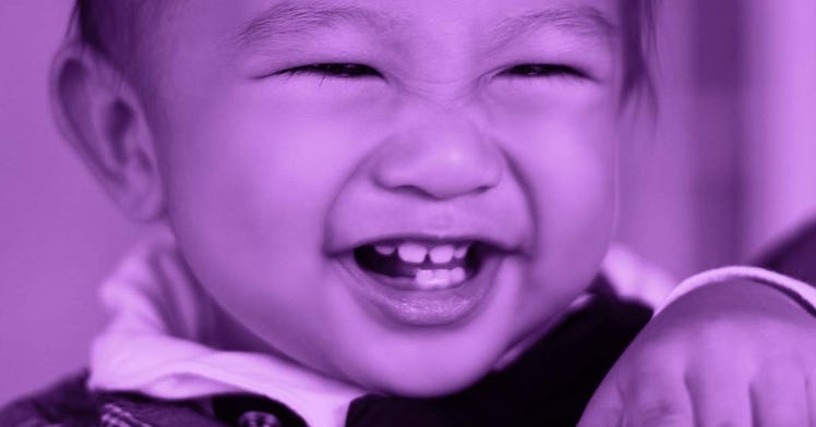 A smiling baby showing teeth that touch together