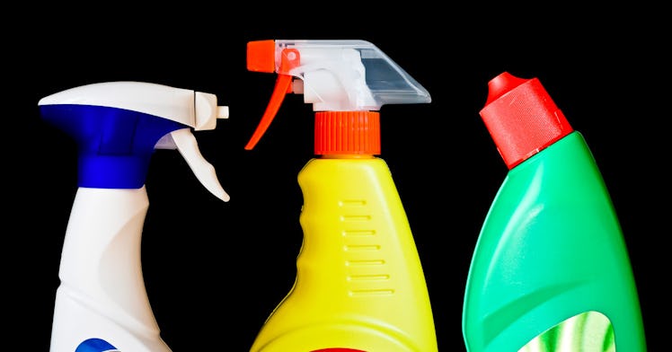 Three cleaning product bottles on a black background