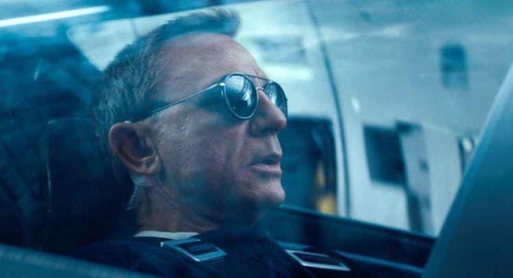 Daniel Craig in cockpit in No Time To Die as James Bond wearing sunglasses