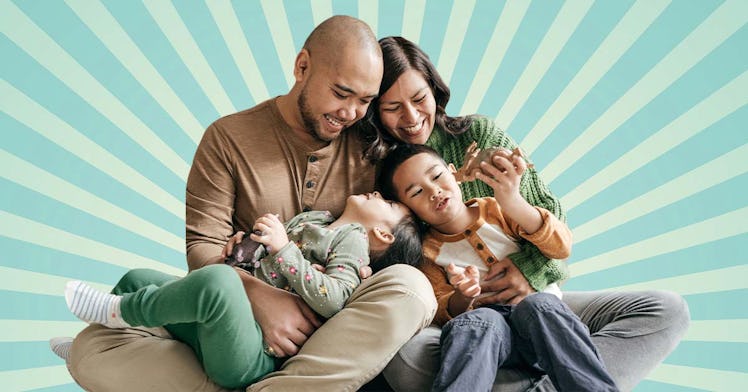 An Asian family smiling and cuddling together against a blue starburst background