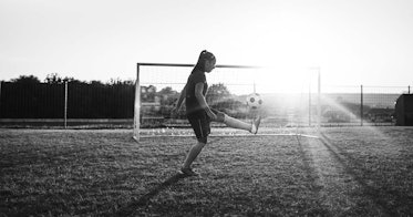 A kid plays soccer