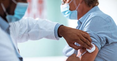 a man gets the COVID vaccine