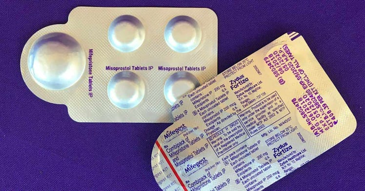 Abortion pills in packaging on a blue background