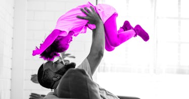 Dad wrestling with daughter by lifting her in the air
