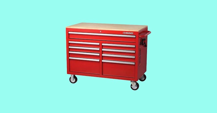 Red rolling toolbox against a blue background, one of our favorite tool storage options