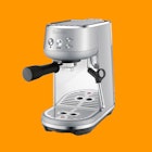 The The Bambino by Breville Espresso machine on an orange background