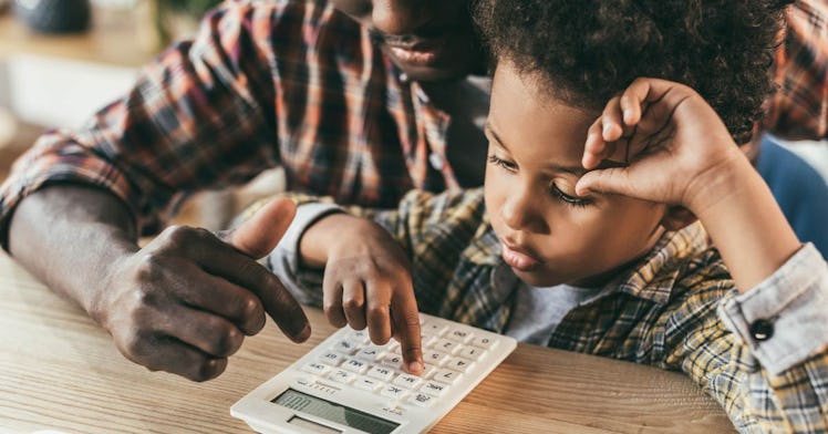 A parent and a baby use a calculator