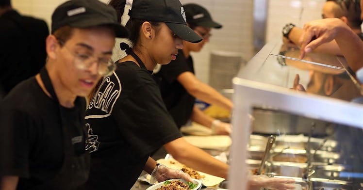 A group of Chipotle employees serve food