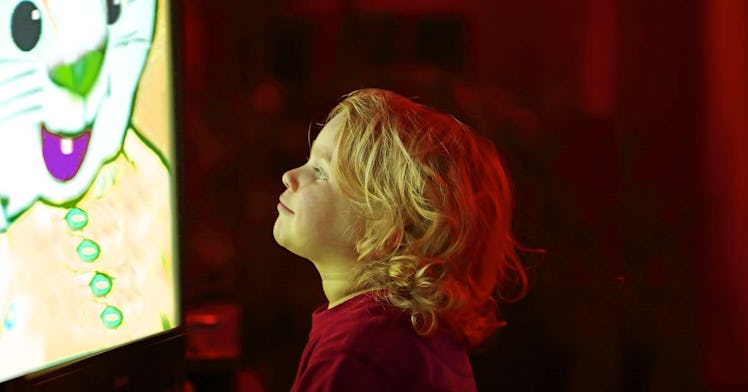 A toddler stares at a cartoon screen