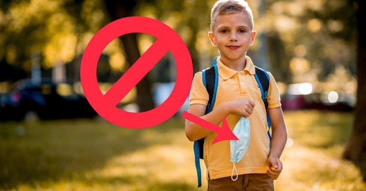 A kid holds a mask
