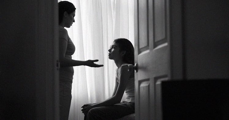 A couple having a discussion as seen through an open bedroom door