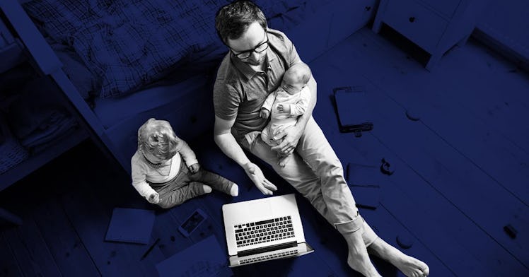 Two children and a father sit in front of a laptop, ensconced in blue