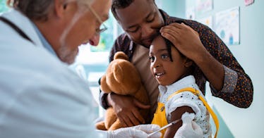 A dad hugs his child at a doctor's office