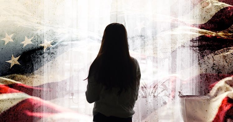 A kid stands alone, looking at a background of a tattered flag