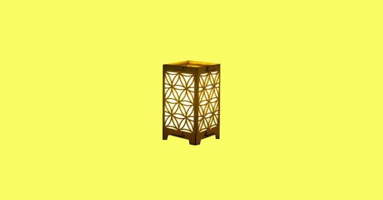 a friendship lamp with a carved-wood design against a bright yellow background